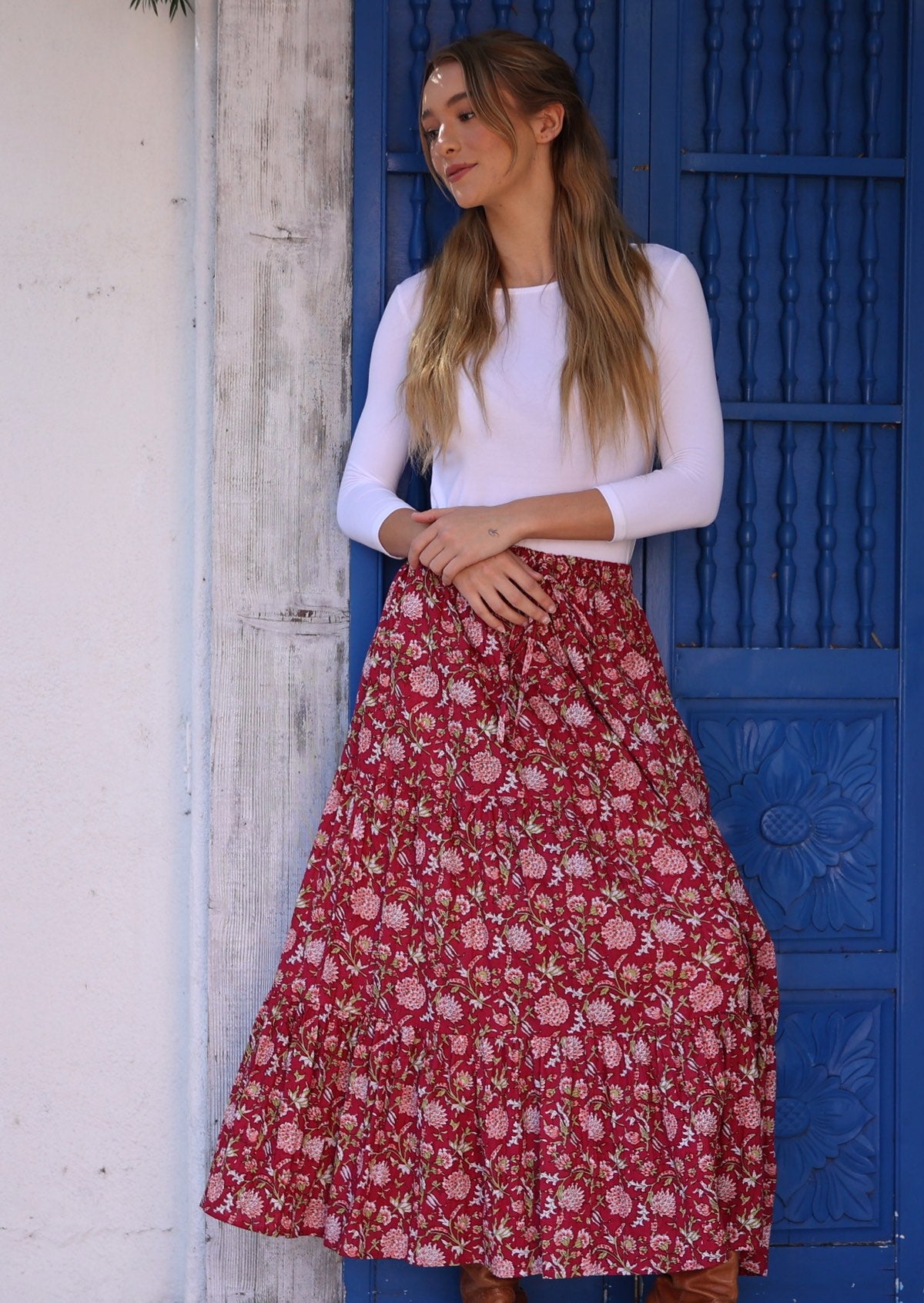 Model wears crinkled cotton skirt with elastic waist and drawstring.