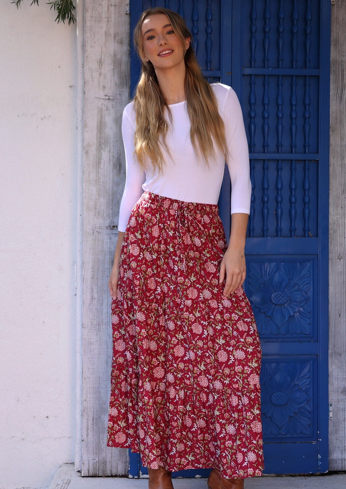 Model wears cranberry based 3 tiered cotton skirt with elastic waistband and drawstrings.