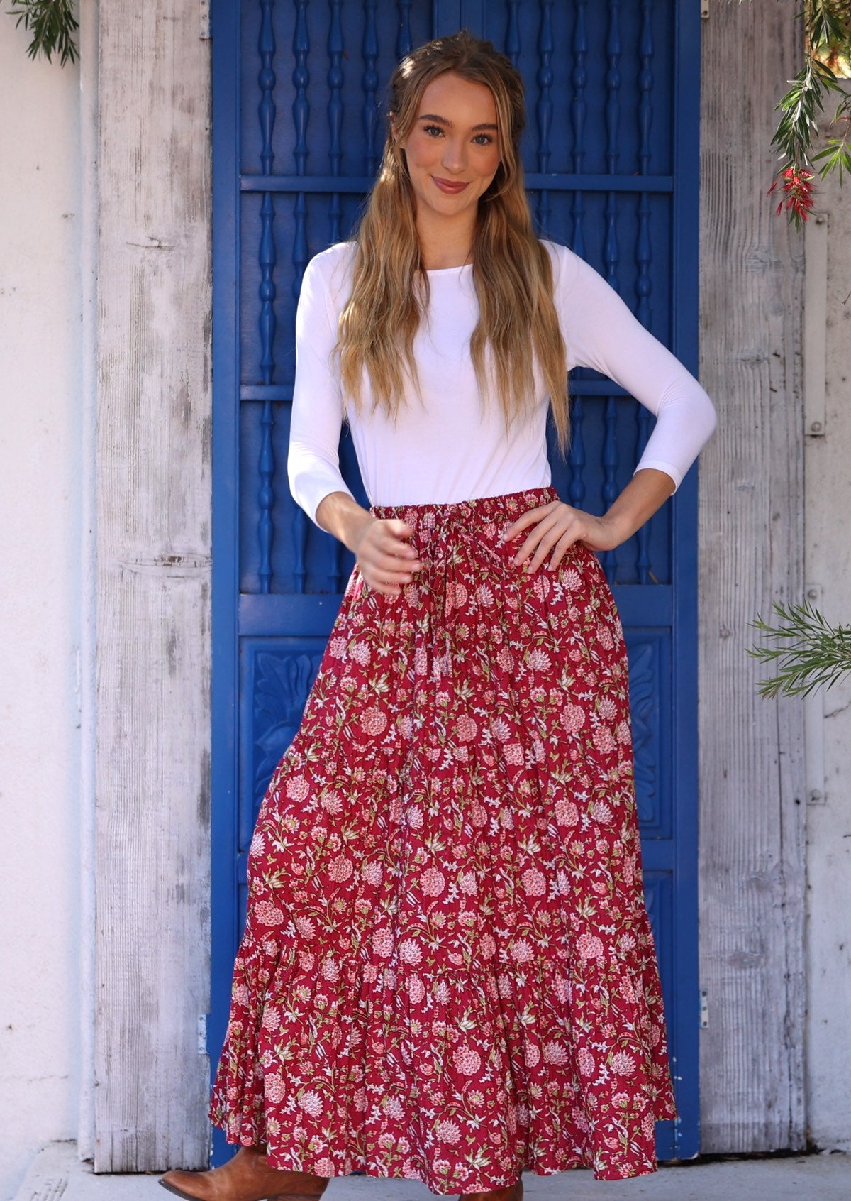 Model standing in front of blue door wearing 100% cotton maxi skirt with elasticised waist and drawstring.