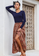 Model in skirt pull up pose wears 100% cotton, floral print maxi skirt with elastic waist.