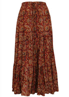 Cotton tiered maxi skirt with elastic waistband and drawstring, in earthy floral print on rust base.