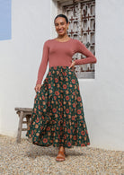 Model wears green based 3 tiered cotton skirt with elastic waistband and drawstrings.