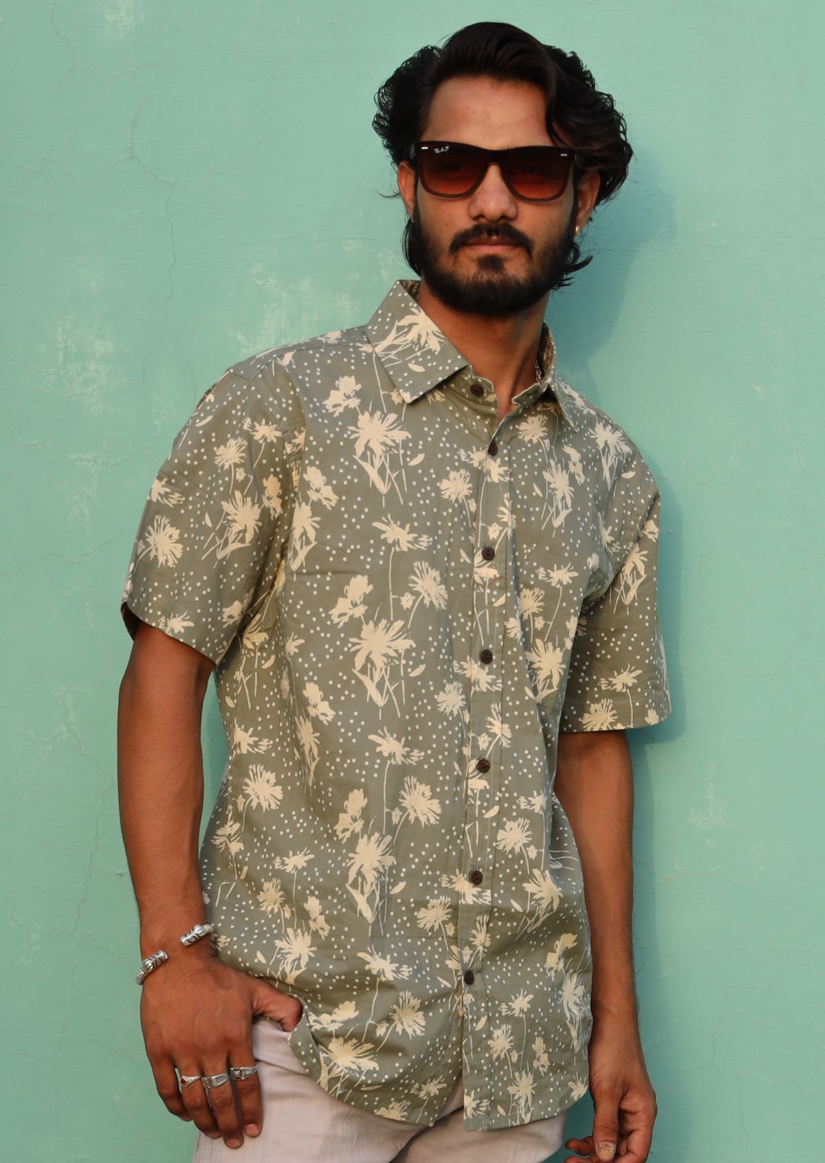 Man wearing a lightweight relaxed fit 100% cotton shirt with short sleeves and coconut buttons.