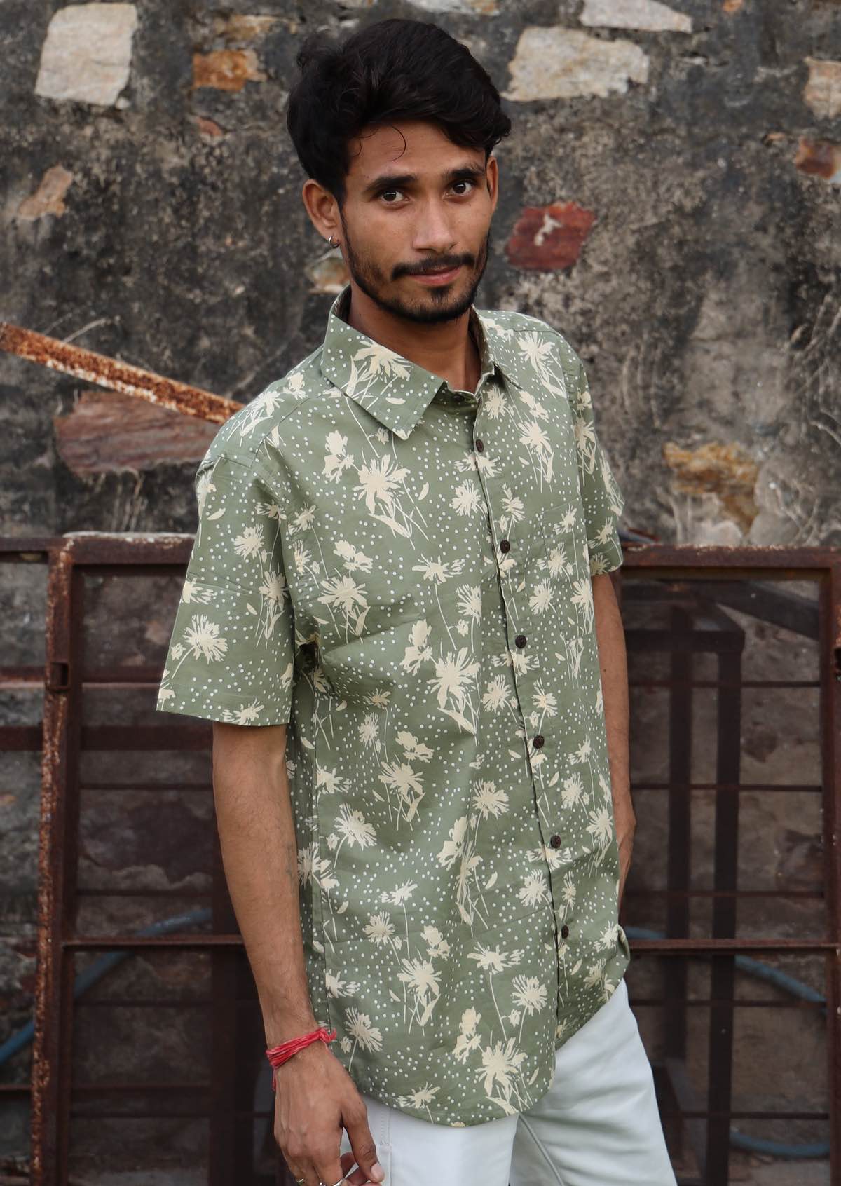 Model wears 100% cotton collared shirt with one chest pocket, coconut buttons and short sleeves.