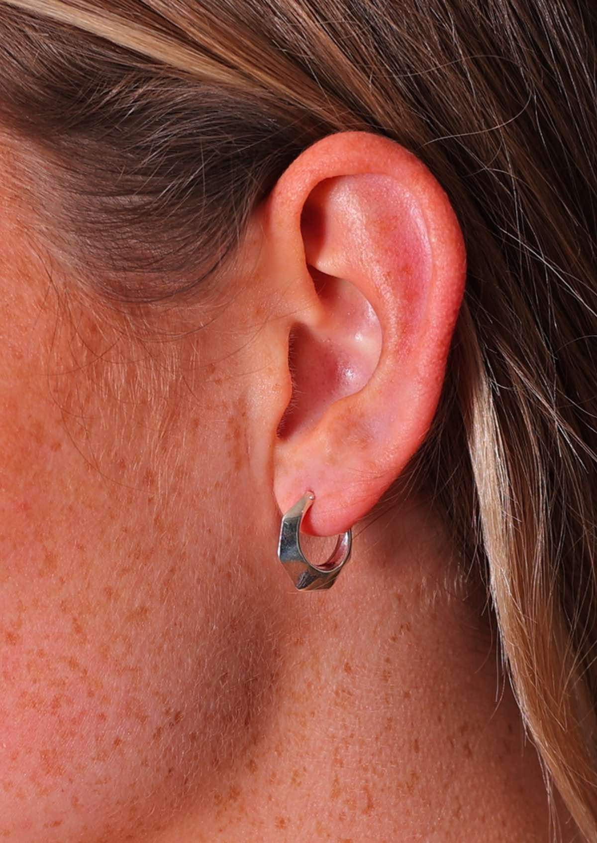 Close up of sterling silver 16mm diameter hollow hoop earrings with six 'sides' and subtle faceting