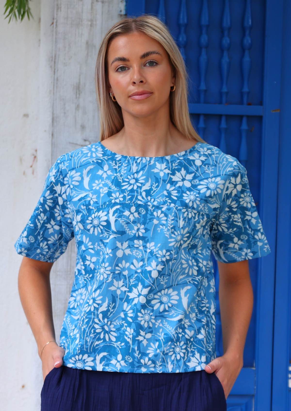 100% cotton blue floral boxy style blouse on woman with blonde hair