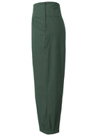 Side view of wide leg tapered cotton pants in plain green with side zipper and pockets