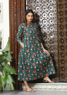 Model wearing a 100% cotton midlength dress with 3/4 sleeves and hand in pocket.