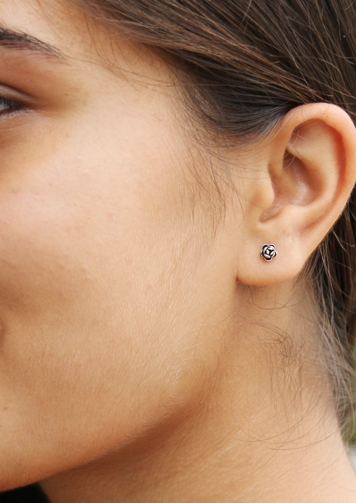 Women wearing a small perfect peony flower studs with secure butterfly backs