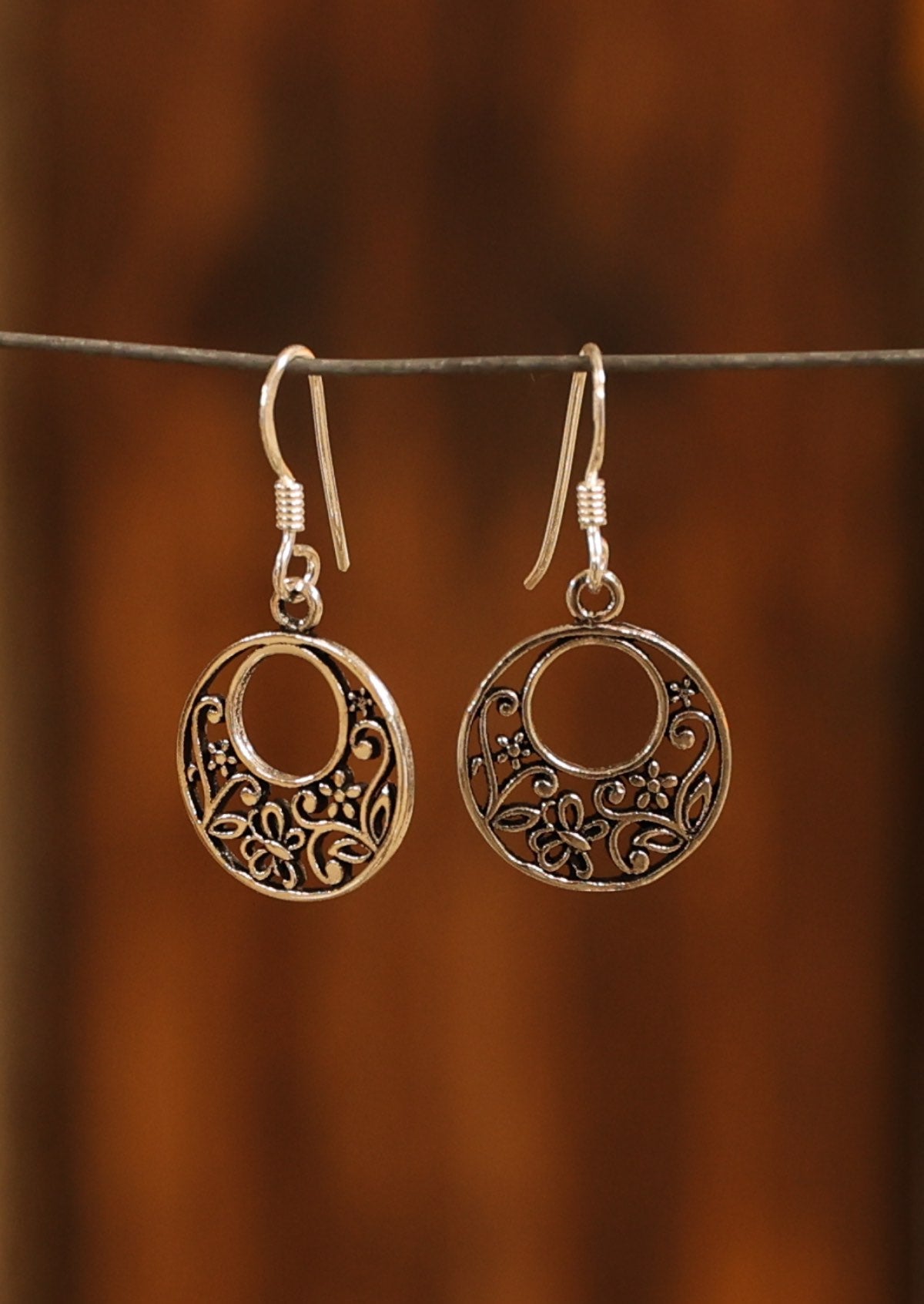 Sterling silver circle earrings with floral detail