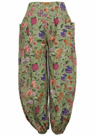 Green based multi-coloured floral print cotton harem pants with buttoned ankles with pockets.