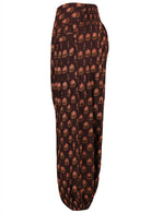 Side image of 100% cotton boho style pants with printed floral pattern on brown base.