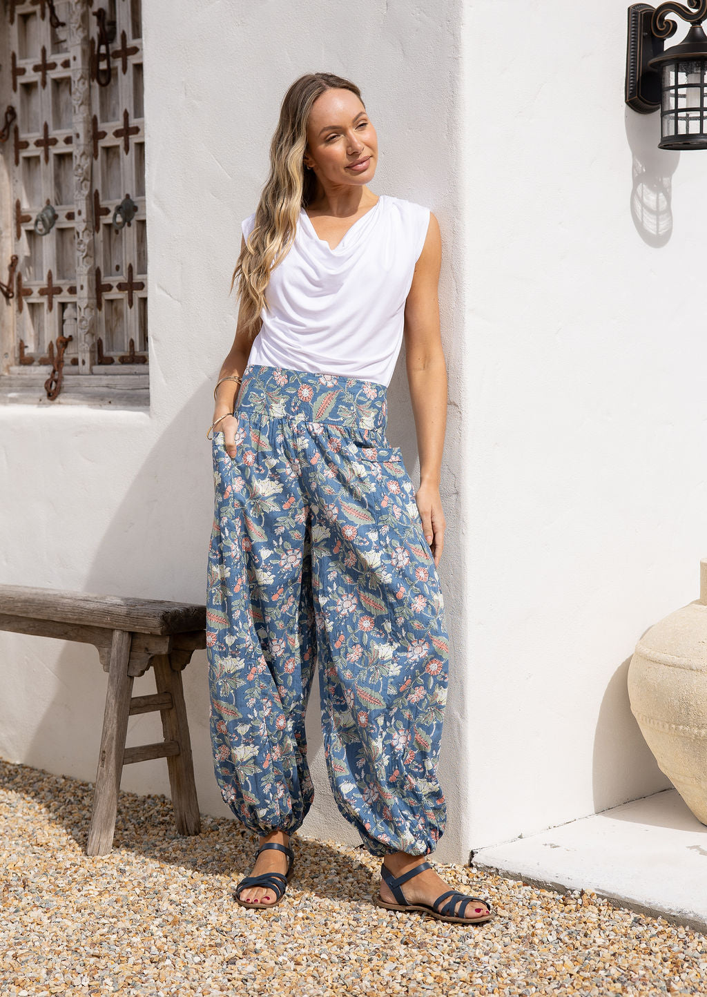 Models stands in sun wearing a 100% cotton harem style pants with elasticated waist and ankles