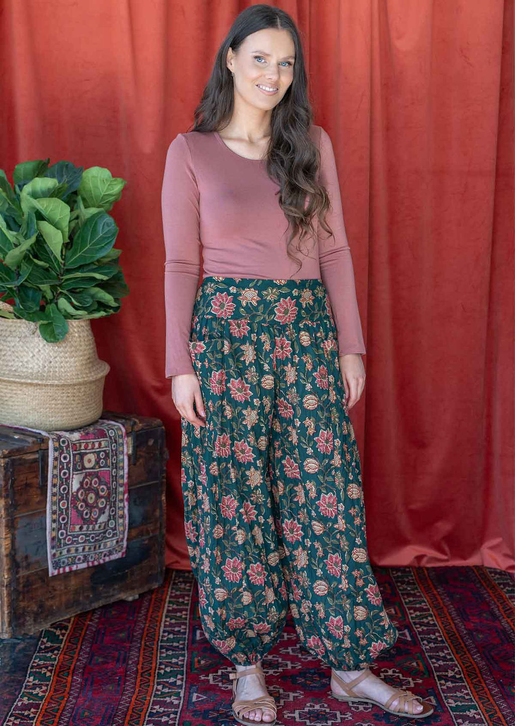 Model wears cotton harem pants with elasticated ankles, wide waistband and deep pockets.