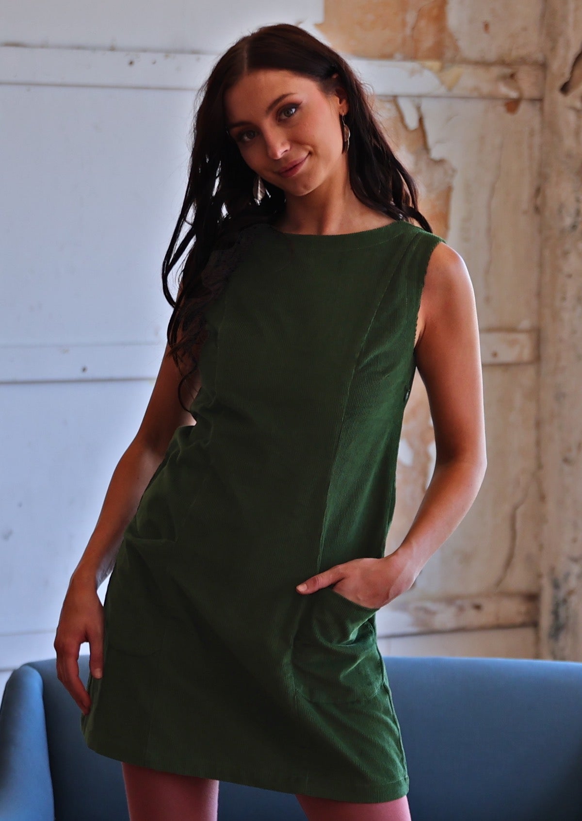 Woman wearing green cotton corduroy tunic with hand in pocket