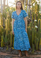 woman in blue cotton floral v neck maxi dress