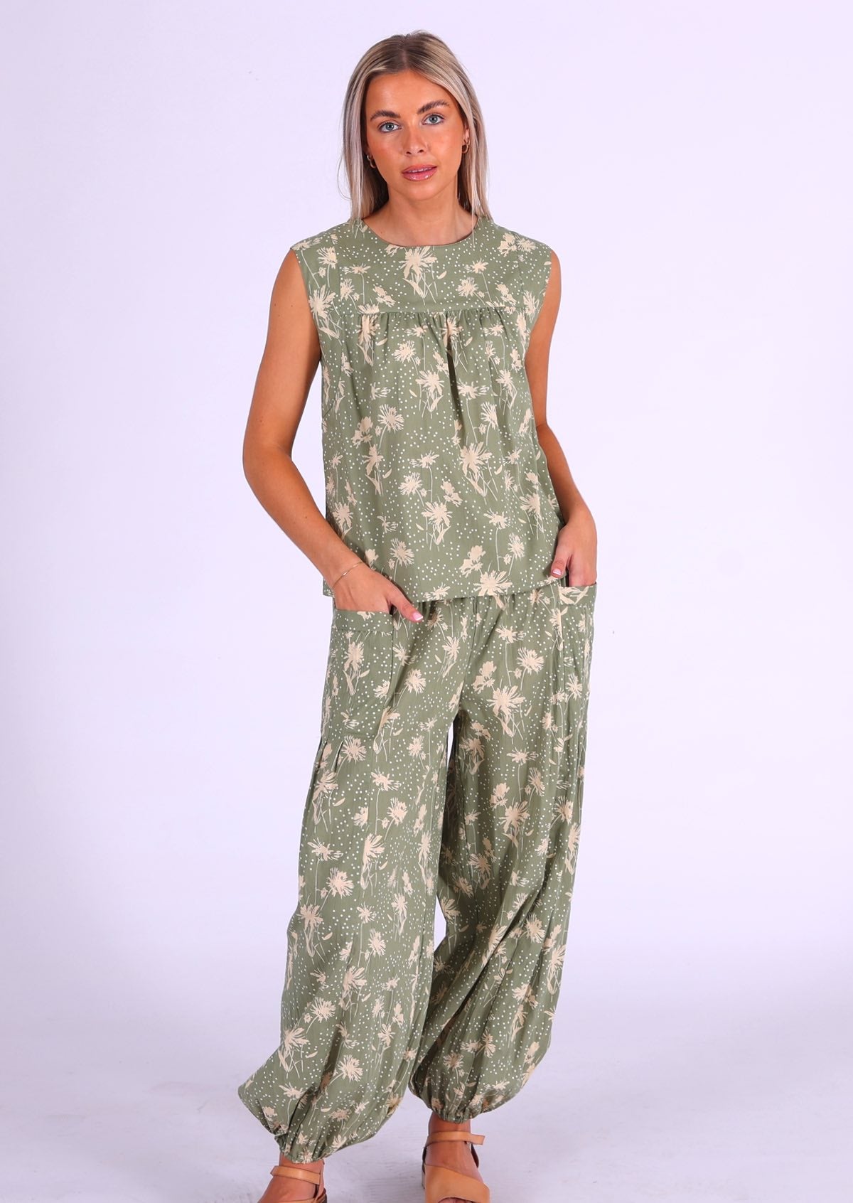 Model stands in matching print sleeveless cotton top and harem pants, that give a faux jumpsuit appearance