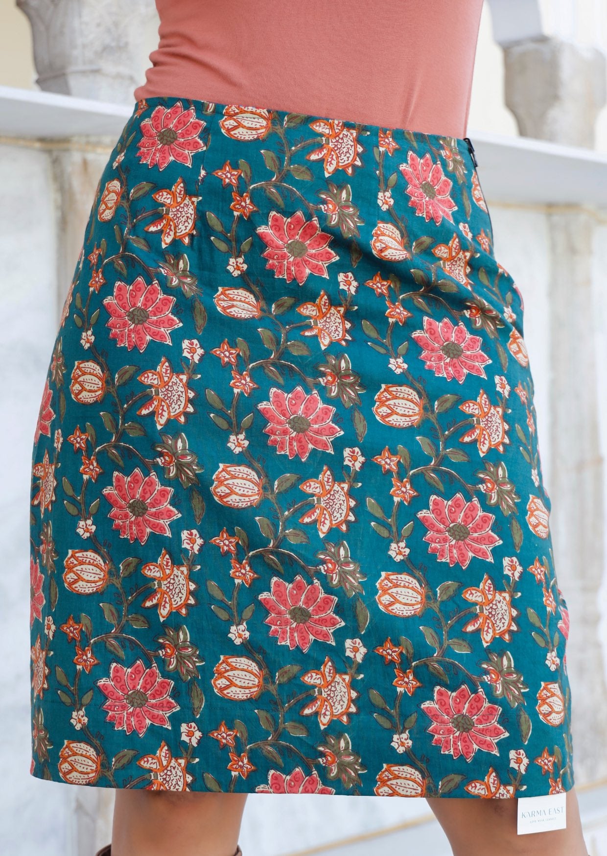 Knee length, cotton reversible skirt with bold pinkish florals on deep green base.