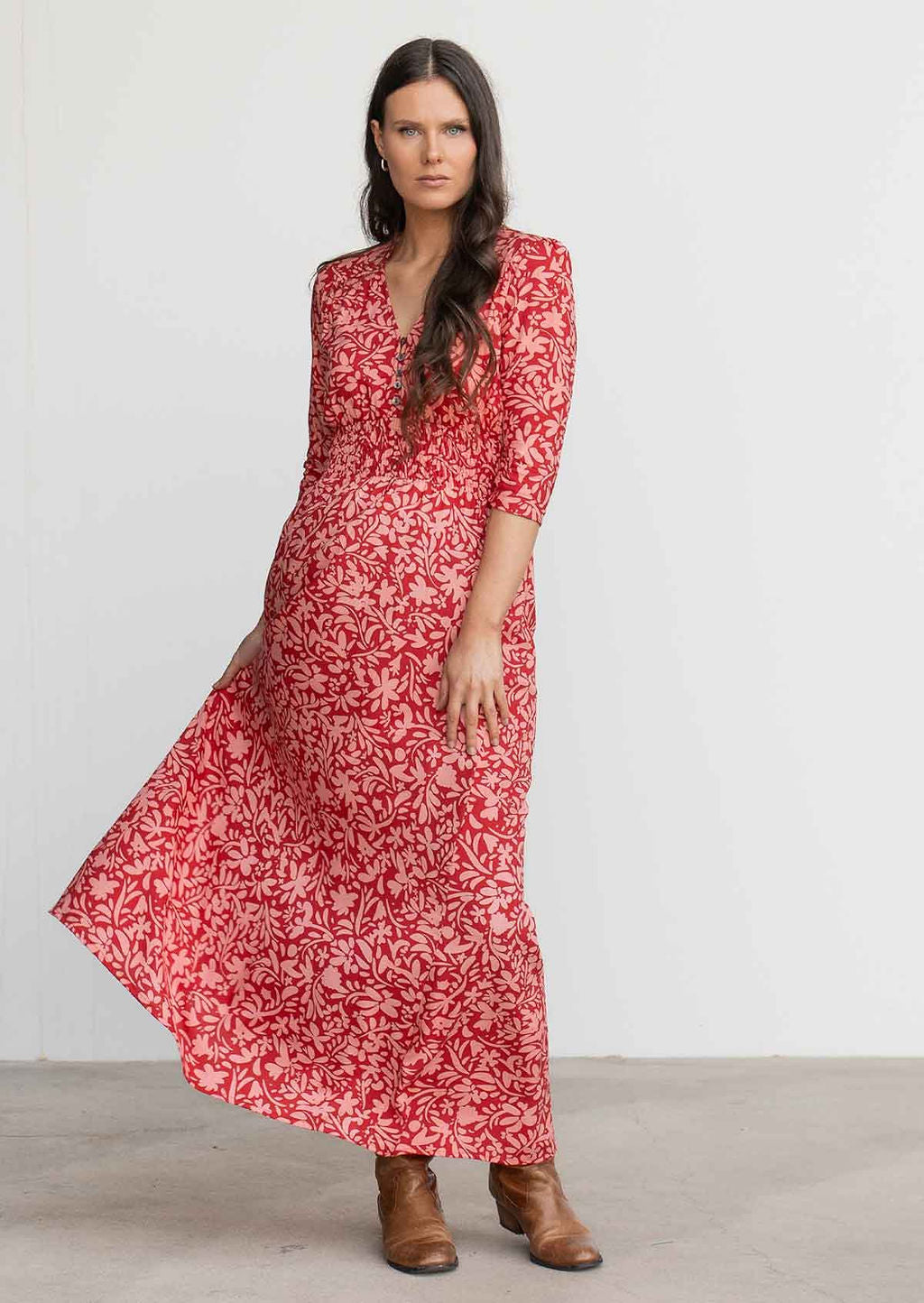 Woman swishes skirt of rayon maxi dress with 3/4 sleeves and elastic ruched waistline