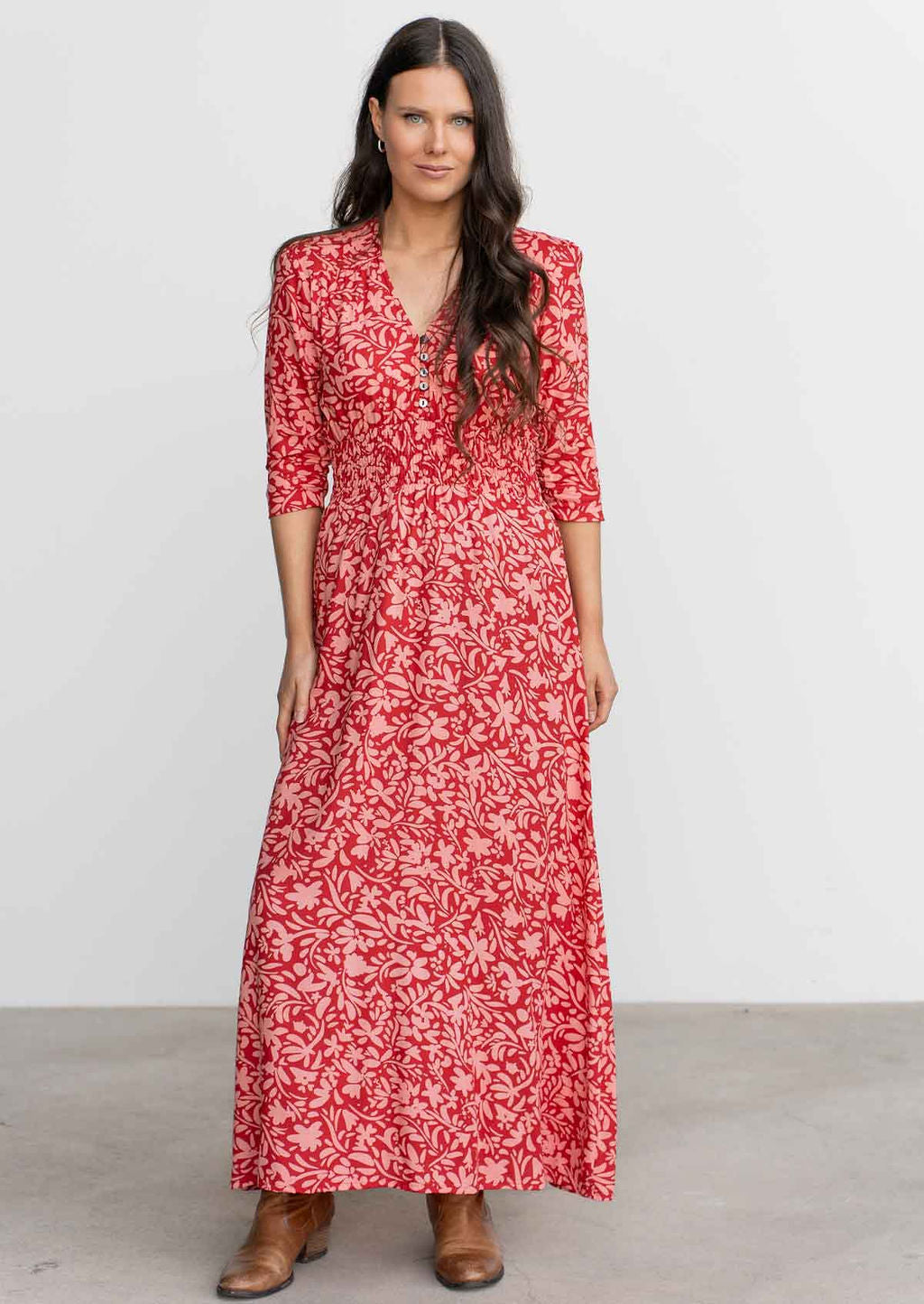 Model wears floaty rayon maxi dress with buttoned bodice with V-neckline and 3/4 sleeves