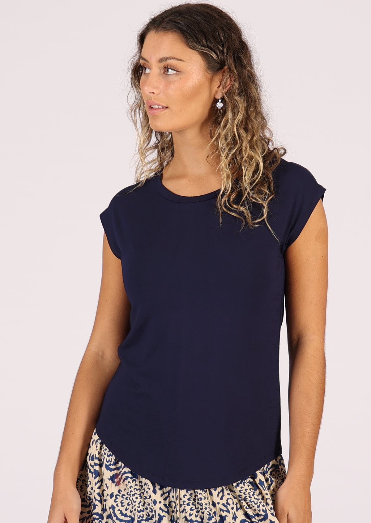 Woman with blonde hair wearing a soft flattering fit navy blue rayon jersey t-shirt.
