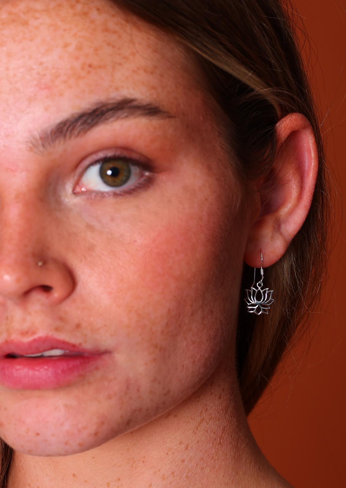 woman wearing lovely silver lotus dangly earrings