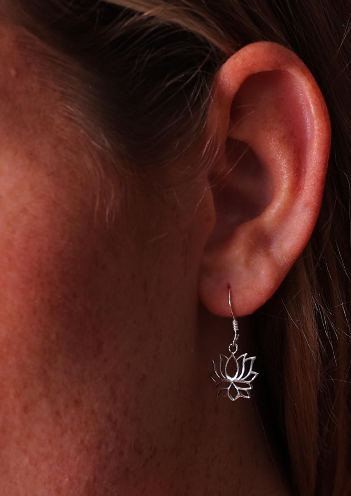 woman wearing lovely silver lotus hook earrings