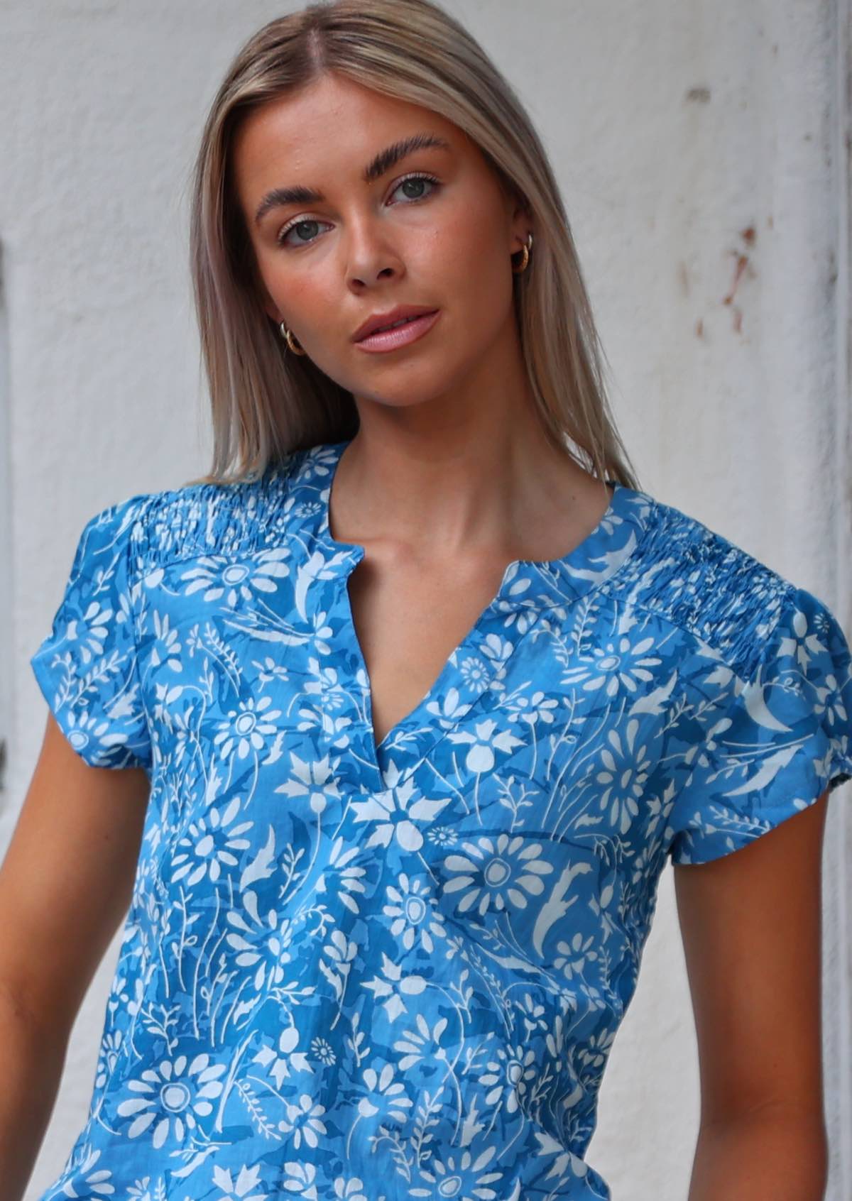 Close up of the elastic ruched detail at the front of the shoulders and the V-neckline