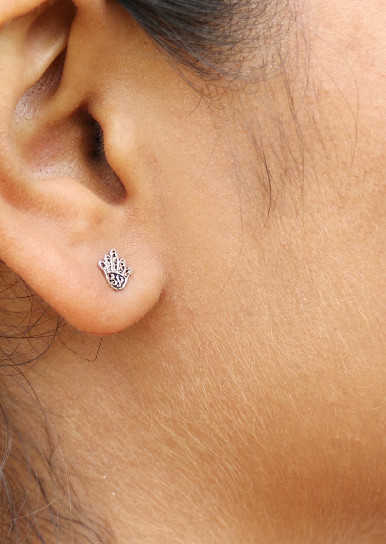 Delicate sterling silver Hand of Fatima studs with intricate lacework and secure butterfly backs