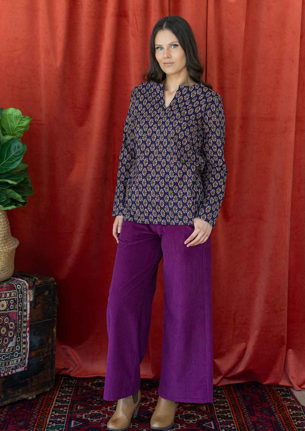 Model wearing long sleeved 100% cotton top in dark purple with corduroy pants plum.