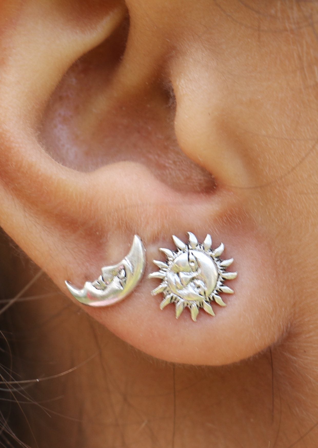 Sterling silver sun and moon studs with delicate engraved faces and butterfly backs