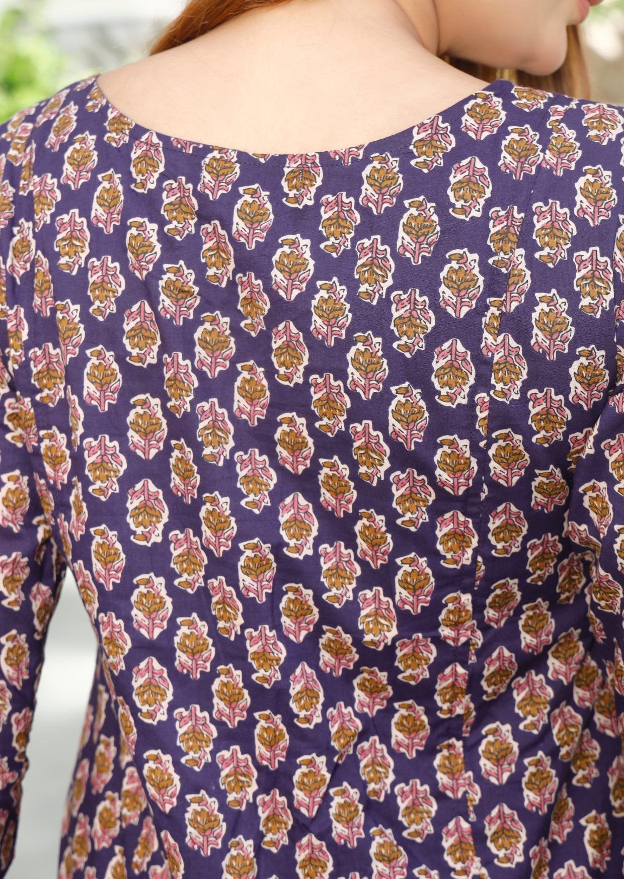 Close up image of back of the dress showcasing beautiful purple based floral print.