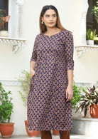 Relaxed fit, knee length cotton dress with 3/4 sleeves in pink and light brown floral print on dark purple base.