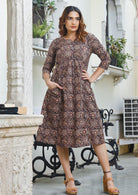 Fully lined cotton dress with round neckline, 3/4 sleeves and pockets in earthy brown based floral print.