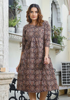 Model wearing lightweight 100% cotton dress with relaxed fit, 3/4 sleeves and pockets with pin tucks.