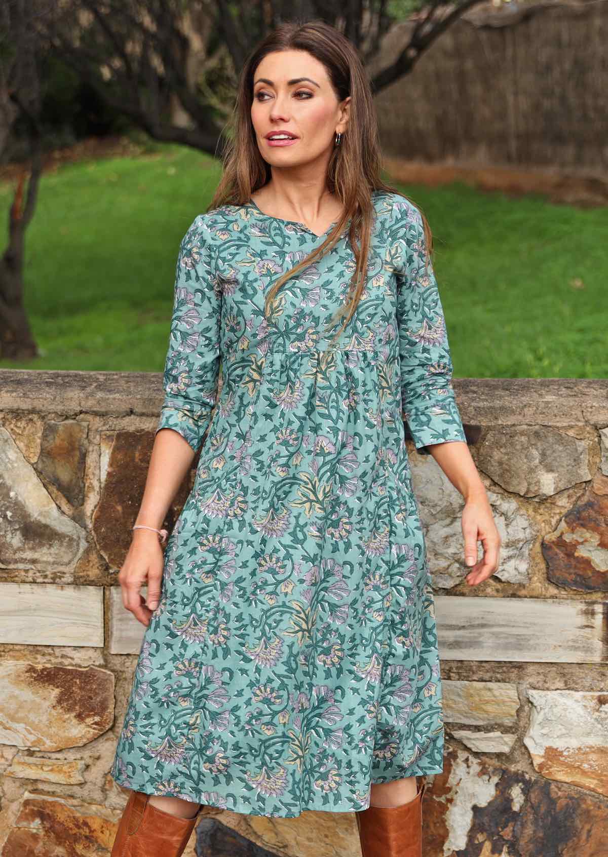 Model wearing 100%  cotton dress with beautiful floral print in green tones.