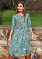 Model wearing 100%  cotton dress with beautiful floral print in green tones.