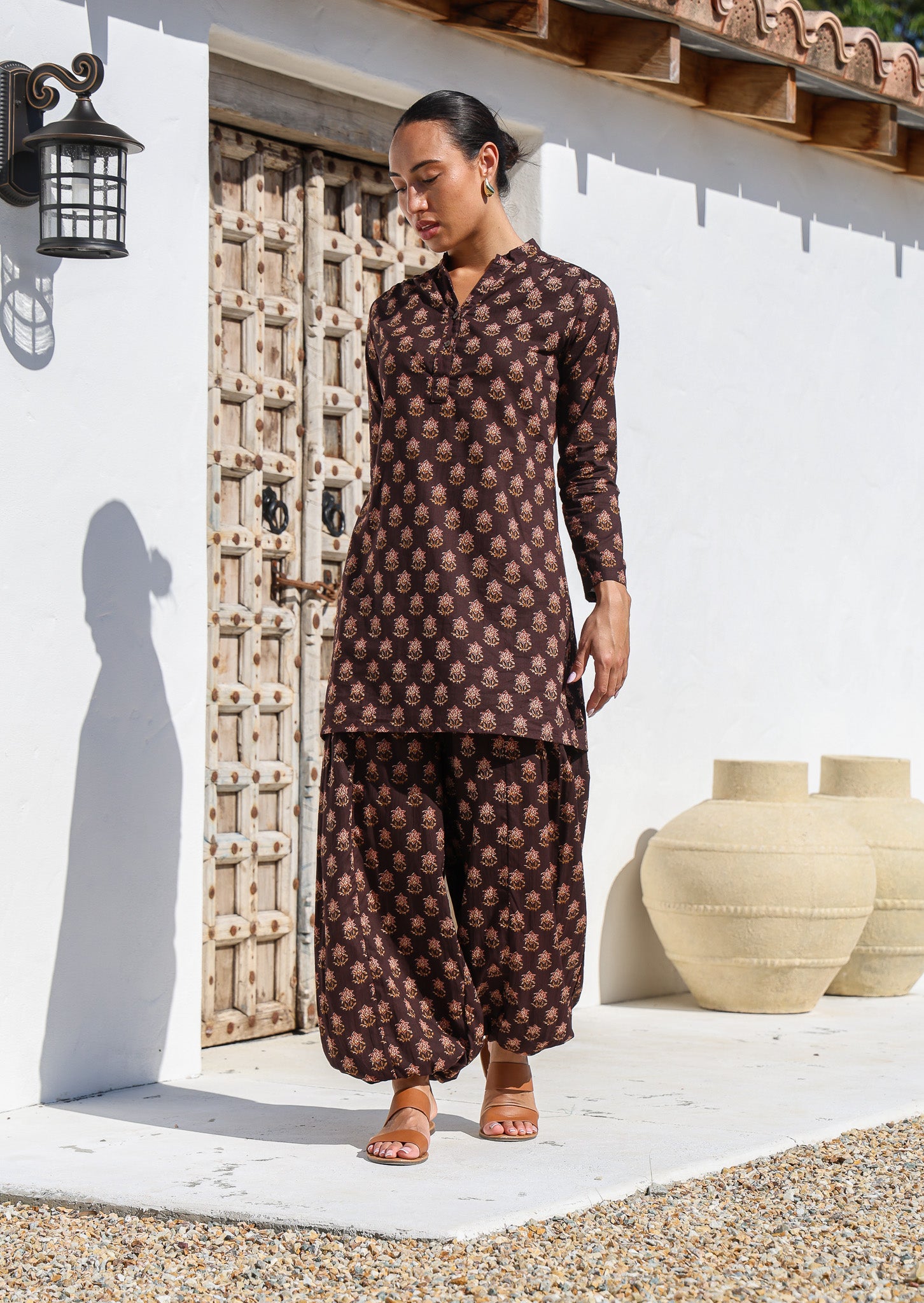 Model wears 100% cotton long sleeve tunic in dark brown floral print with brown floral cotton pants.