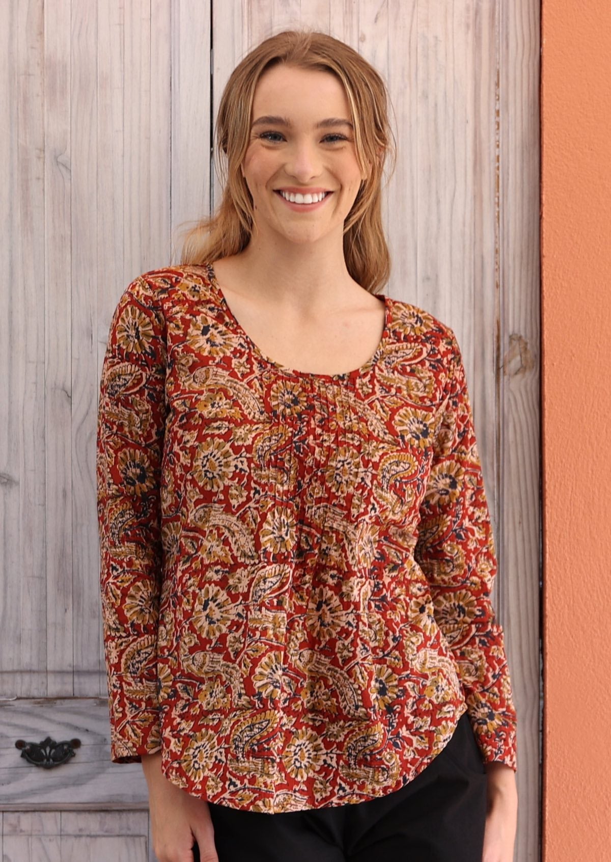Woman wearing long sleeve earthy toned Indian print cotton blouse