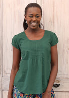 Model wears a top with U-shaped neckline and cap sleeves.