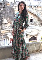 Model wearing a 100% cotton 3 tiered maxi dress with 3/4 sleeves, buttoned bodice and one hand in pocket.