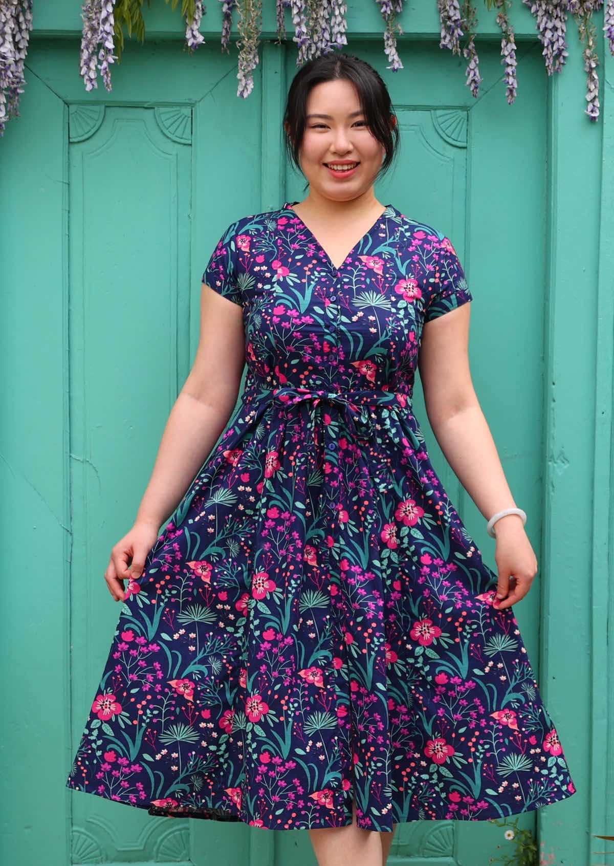 Woman standing in Navy cotton floral maxi dress with v-neck