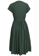Back view of 100% cotton midi length button through dress with high round neckline and fabric waist tie