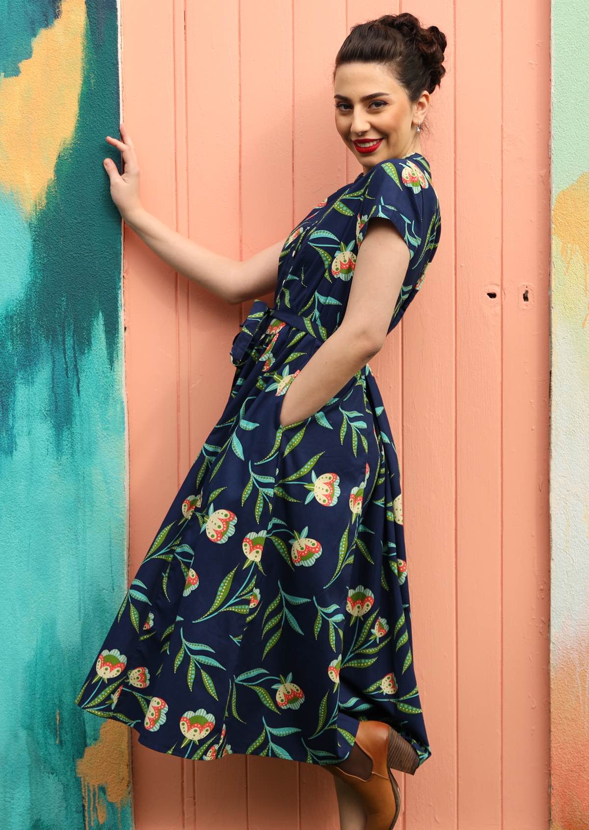 Model wears a long dress with pockets.