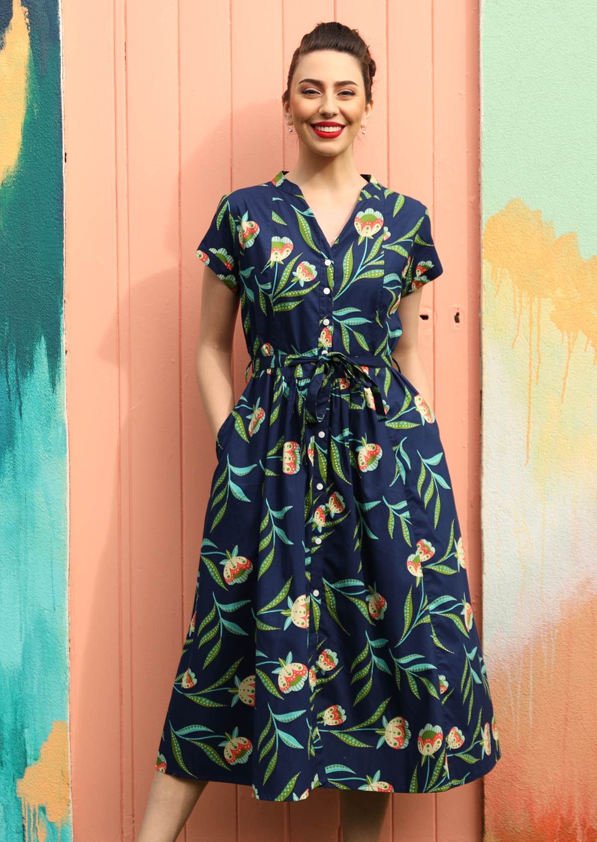 Model wears a dress with pleats in the centre.
