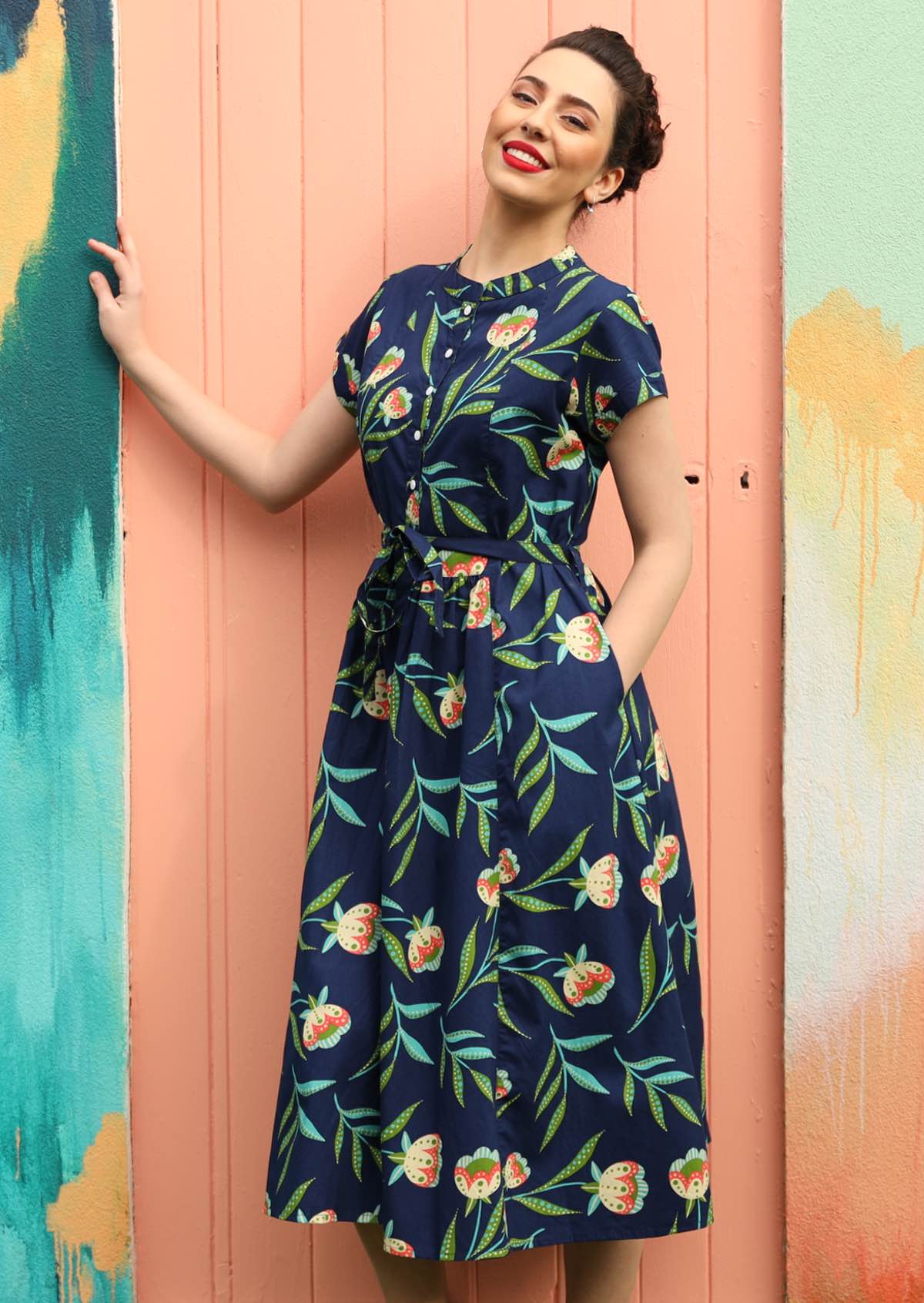 Model wears a dress that ends at the shin.