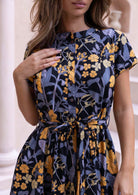 100% cotton button through floral dress with removable waist tie, waist pleats and short sleeves.