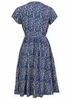 Back mannequin photo of 50's style cotton midi length button through dress with cap sleeves, high round neckline and fabric waist tie