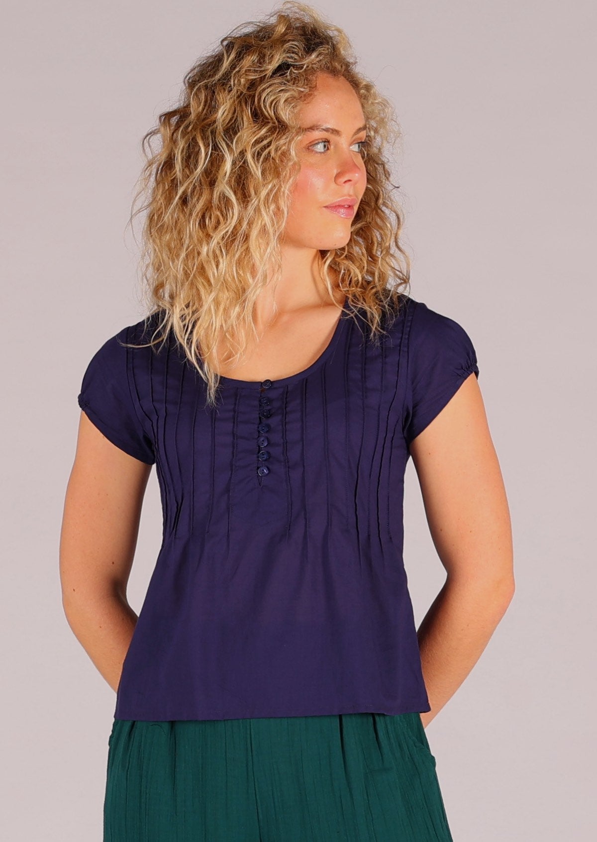 Model wears 100% cotton scoop neck short sleeve top in dark blue