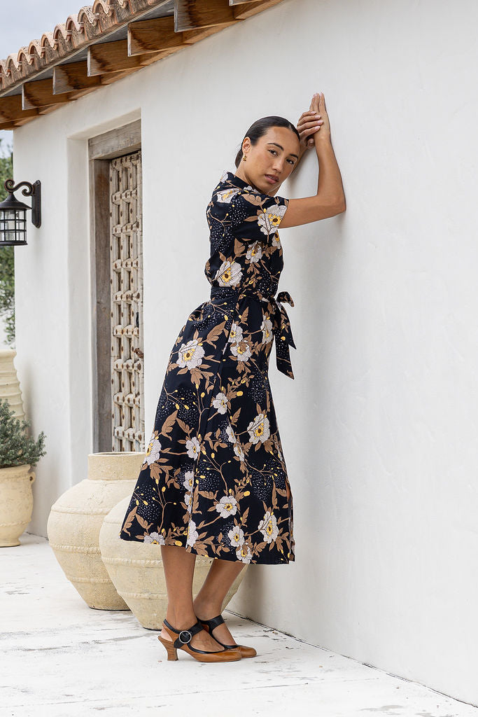 Woman wearing cotton shirt dress with collar and T-shirt sleeves.